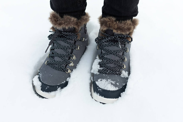 Picture of a comfortable women's warm boots in the snow - Photo, image
