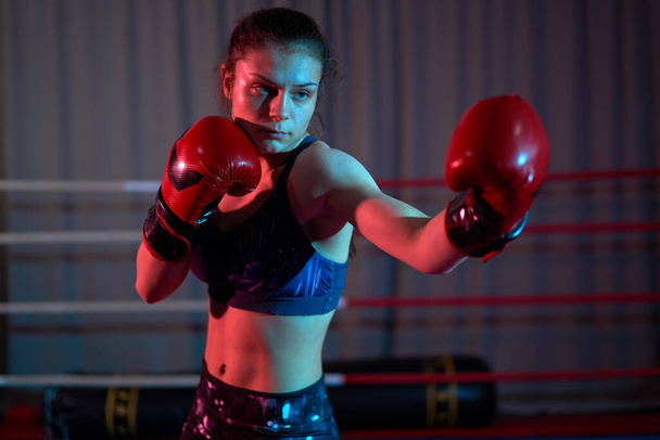 Kick-boxer girl training in ring - Фото, изображение