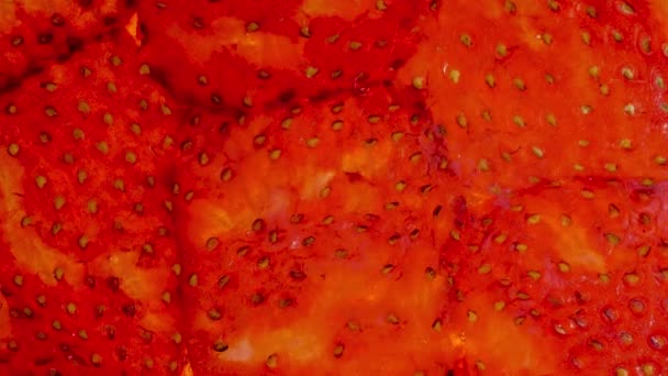 Macro 4k footage of squeezed and crushed strawberries. Perfect abstract backdrop for organic food and healthy nutrition. Closeup of juice flowing out of berries - Footage, Video