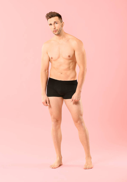 Handsome man in underwear on color background - Фото, зображення