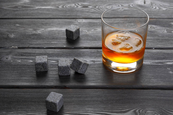 Whiskey and whiskey stones on a wooden table - Φωτογραφία, εικόνα