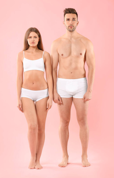 Young couple in underwear on color background - Фото, зображення