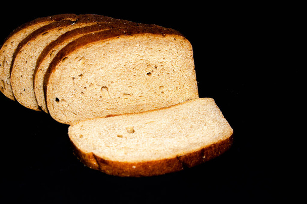 Hearth, pood bread. Black, gray, mustard. Sliced in slices, slices, slices on a choppy background. Top view, side view. Copy Space - Photo, Image