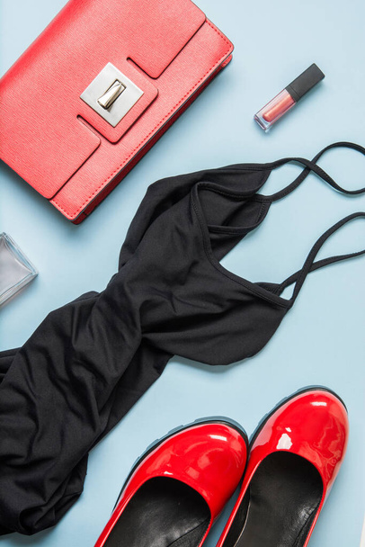 Elegant little black dress and classic red accessories for special date. Flat lay, top view. Copy space. Vertical format. - Zdjęcie, obraz