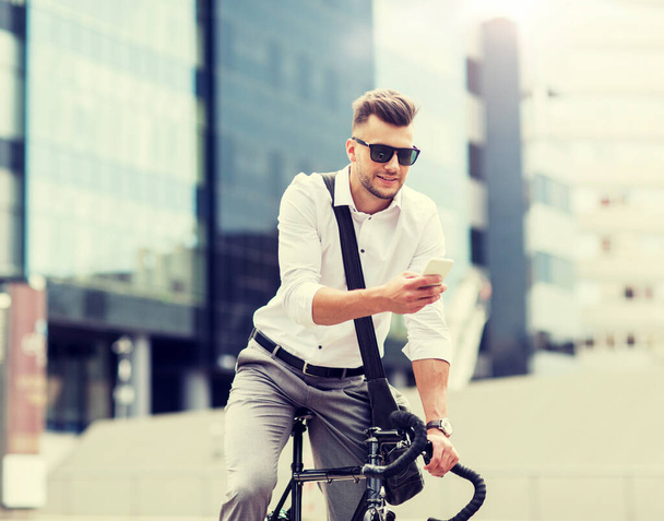 man with bicycle and smartphone on city street - Valokuva, kuva