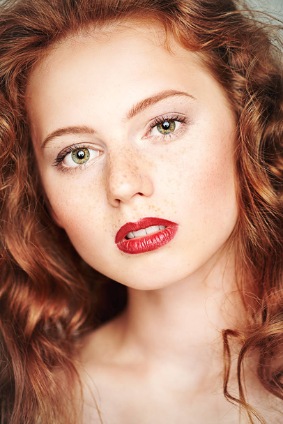 Uzun kızıl saçlı ve güzel yeşil gözlü bir kızın yakın çekim portresi. Makyaj ve saç konsepti. Güzellik portresi. - Fotoğraf, Görsel