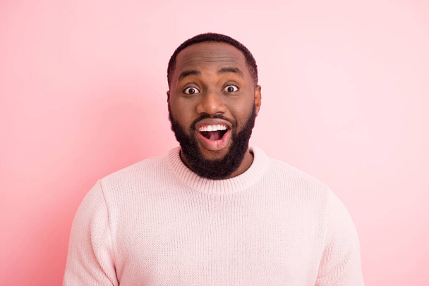 Closeup photo of funny macho dark skin young guy toothy beaming smiling listen good news open mouth wear warm knitted sweater isolated pastel pink color background - Foto, immagini