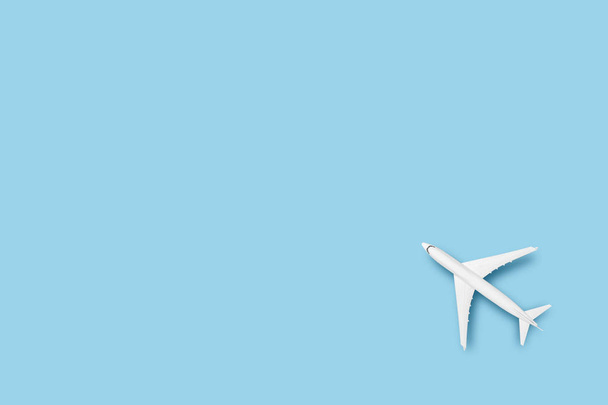 Speelgoedvliegtuig op een blauwe achtergrond. Concept reizen, vliegtickets, vlucht. Vlakke lay, bovenaanzicht. - Foto, afbeelding