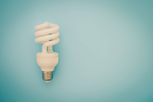 Glowing LED light bulb on blue background for energy savings concept - Fotografie, Obrázek