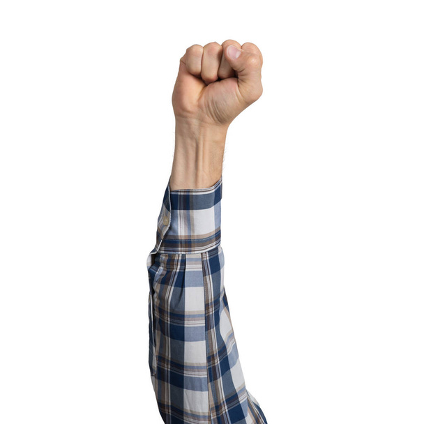 Man hand in blue checkered shirt showing clenched fist gesture. Victory or protest sign. Human hand gesturing sign isolated on white background. Male raised arm presenting popular gesture. - Foto, Imagem
