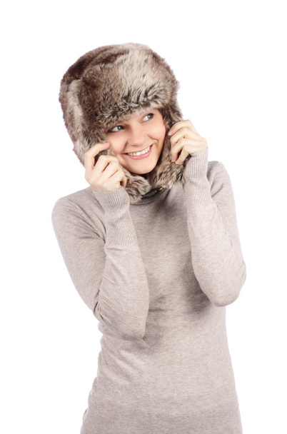 Attractive girl in a fur hat isolated on white - Valokuva, kuva