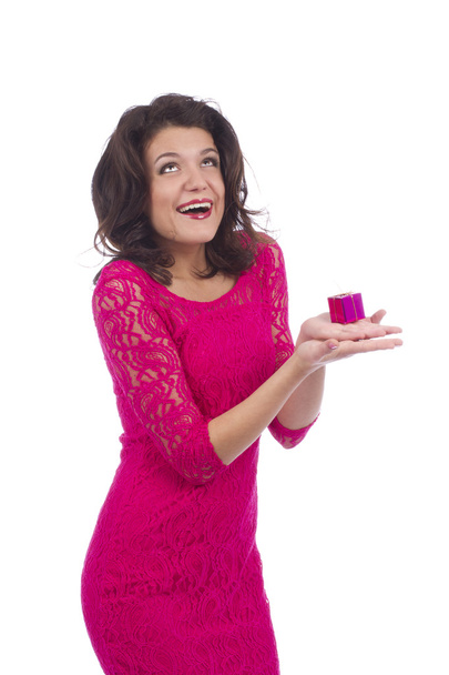 Woman looking up and holding small gift - Foto, immagini