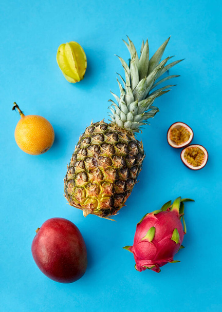 pineapple with other fruits on blue background - Photo, image