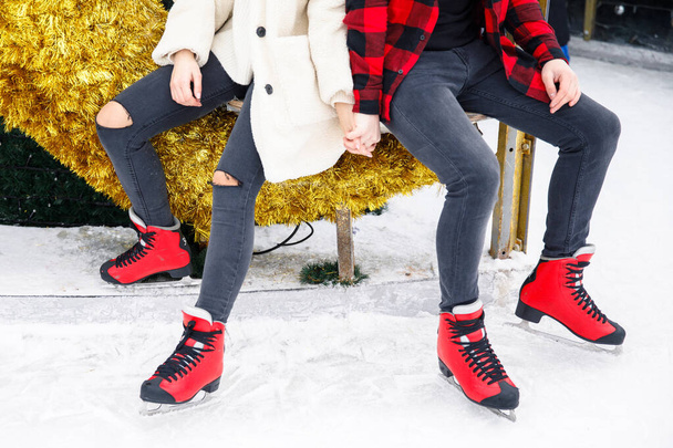 close up of boy and girl legs in skates on ice rink background - Fotografie, Obrázek