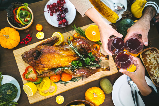 Group of people enjoying dinner with turkey together. Dining Wine Cheers Party thanksgiving Concept - 写真・画像
