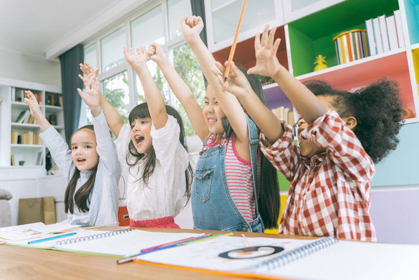 Group of little preschool kids hands up in class . portrait of children diversity education concept. - Foto, Bild
