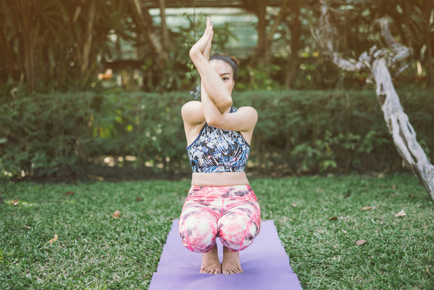 Yoga in the park healthy exercise. - 写真・画像