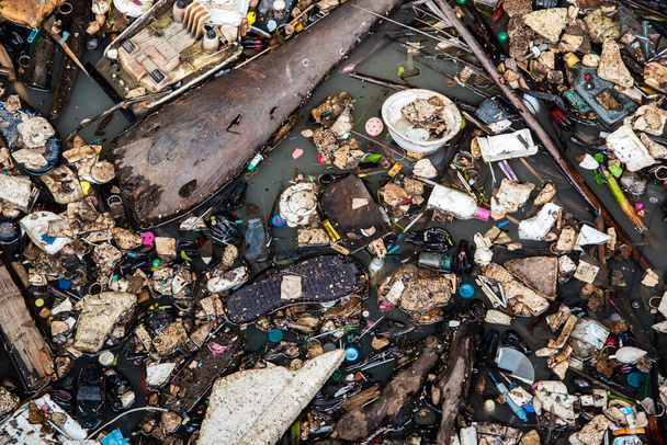Nehirdeki çöpler çevreyi yok ediyor. Dünya Çevre Günü kavramı. - Fotoğraf, Görsel