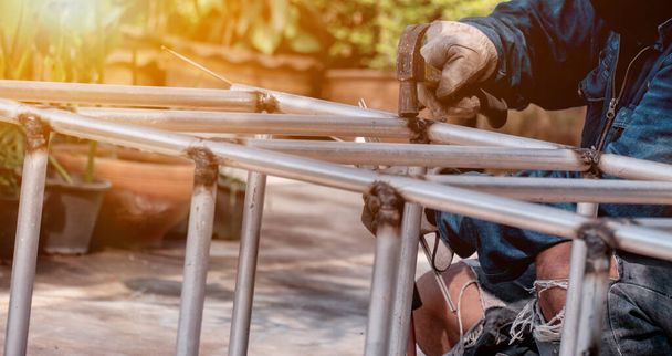 The welder is welding the steel frame. Labor and industrial work hard. - Фото, зображення