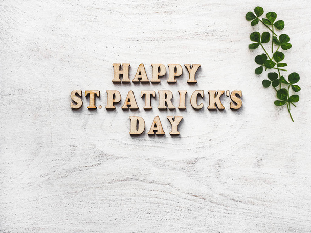 Wooden letters of the alphabet in the form of the words St. Patrick's Day lying on the table. View from above. Isolated background, wooden surface. Congratulations for relatives, friends, colleagues - Foto, imagen
