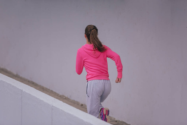 Healthy lifestyle athlete dressed in training clothes exercising - Photo, Image