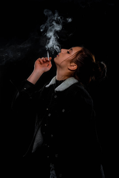 Body shot of a stylish woman posing in black trendy jacket - Valokuva, kuva