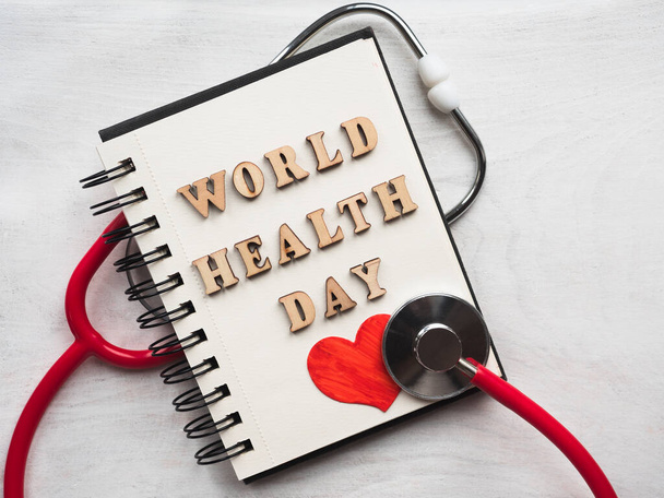 Wooden letters of the alphabet in the form of the words WORLD HEALTH DAY lying on a white table. Beautiful card. Isolated background, wooden surface. Congratulations for relatives, friends, colleagues - Φωτογραφία, εικόνα