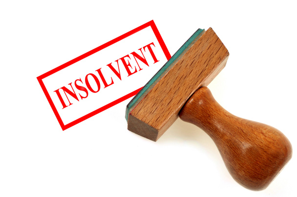 Ink pad showing insolvent in red on white background - Photo, Image