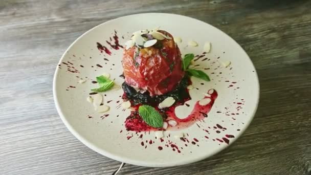 exquisite decorated baked apple with syrup and nuts rotates on plate - Footage, Video