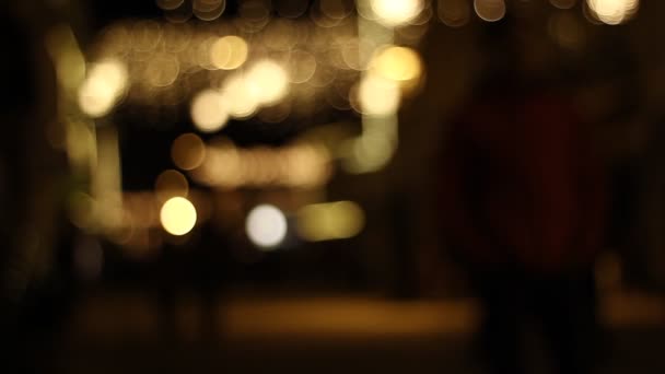 Out of focus of people on the street at night under strong lights. - Footage, Video