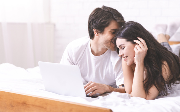Young couple networking on laptop together, empty space - Foto, afbeelding