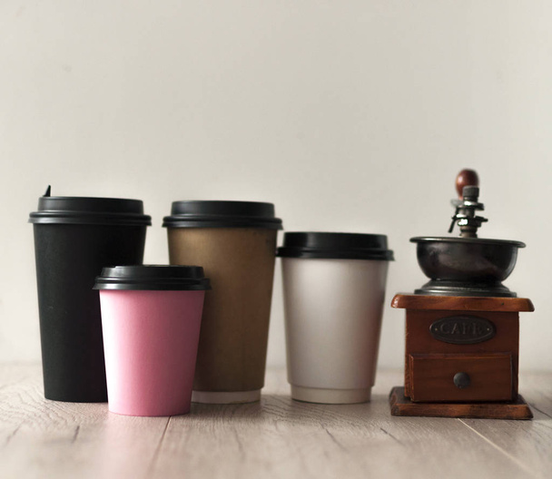 Color disposable paper cups with lids on wooden table - Photo, Image