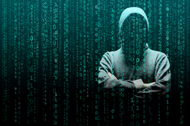 Anonymous computer hacker over abstract digital background. Obscured dark face in mask and hood. Data thief, internet attack, darknet fraud, dangerous viruses and cyber security concept. - Photo, Image