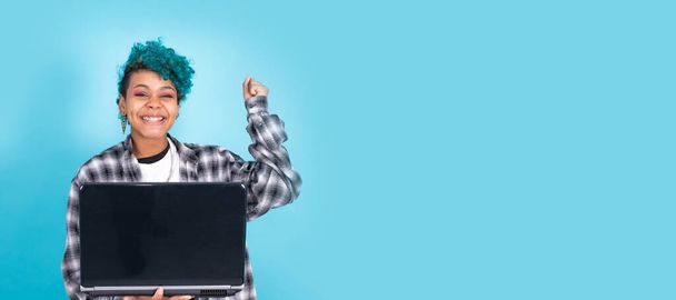 afro american girl with laptop computer isolated on blue background - Photo, Image