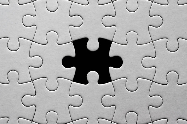 Blank, white jigsaw puzzle close up. One piece is missing - Photo, Image