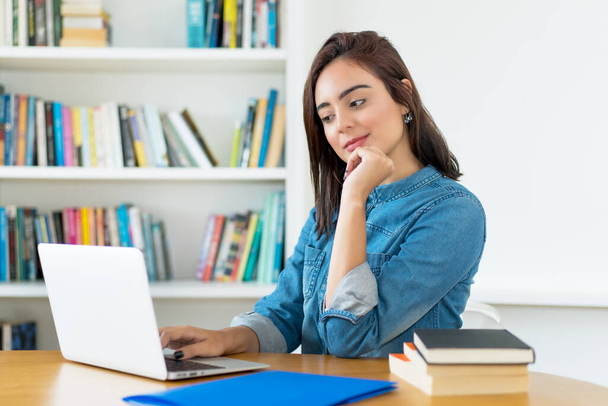 Young adult female student working at computer at university - Φωτογραφία, εικόνα