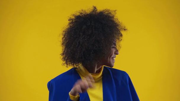 african american girl laughing isolated on yellow  - Séquence, vidéo