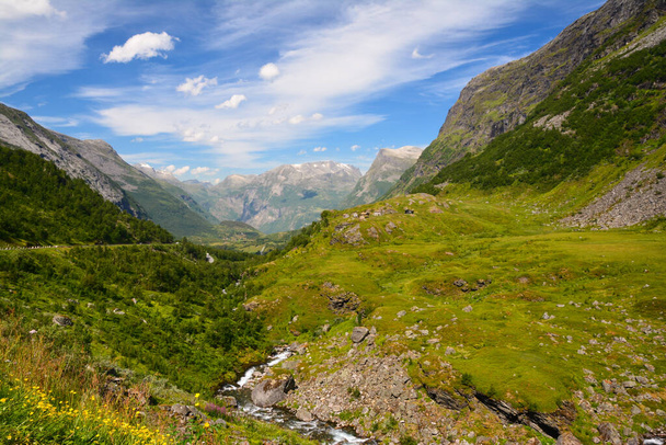 Amazing view on a lush green valley lying in the middle of the norwegian fjords. - Foto, afbeelding