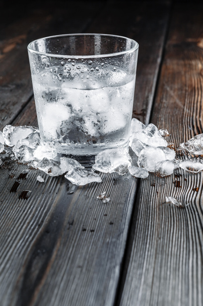 Vodka in shot glasses on rustic wood background - Foto, afbeelding