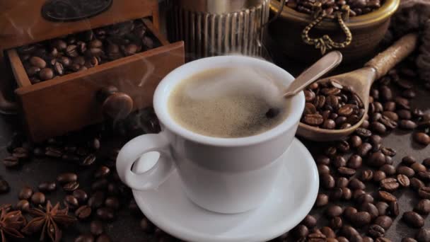 Ζεστός καφές σε ένα φλιτζάνι με ατμό σε ένα παλιό φόντο - Πλάνα, βίντεο