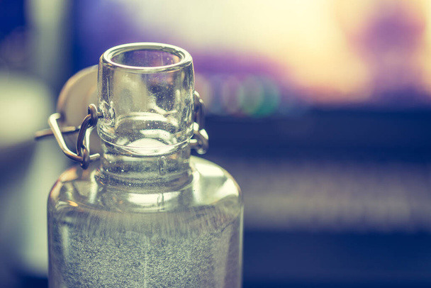 Close up of glass bottle in the office, drinking - Valokuva, kuva