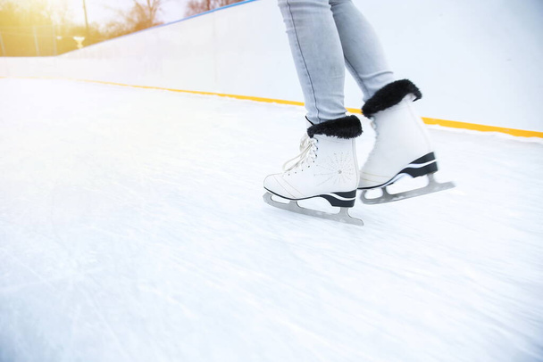 woman is ice skating on rink close up bottom view - 写真・画像
