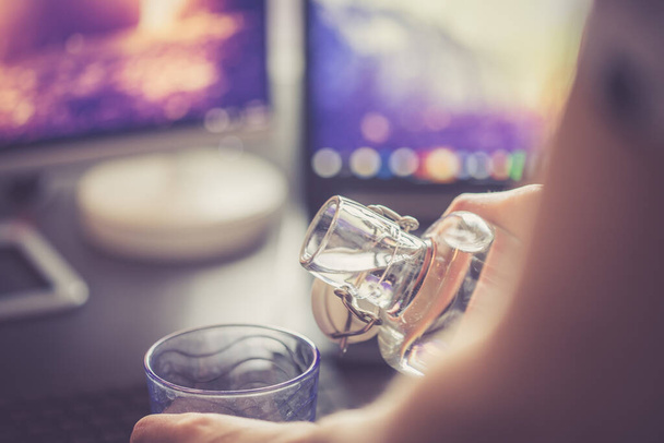 Close up of glass bottle in the office, drinking - Foto, Imagem