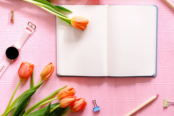 Spring flat lay with orange tulips on pink background. Copy space for a frase or advertisement. - Foto, Bild