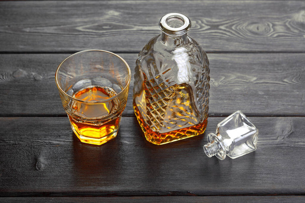 Whisky bottle on dark wooden background flat lay - Фото, зображення