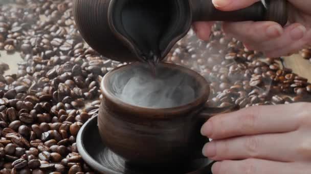 Hot coffee is poured from the coffee maker into the cup. - Footage, Video