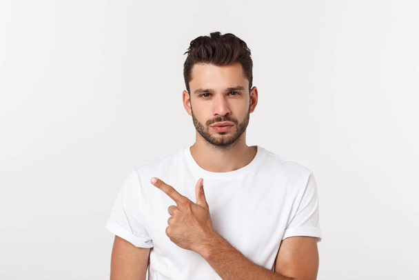 Close up portrait of disappointed stressed bearded young man in shirt over white background. - Photo, Image