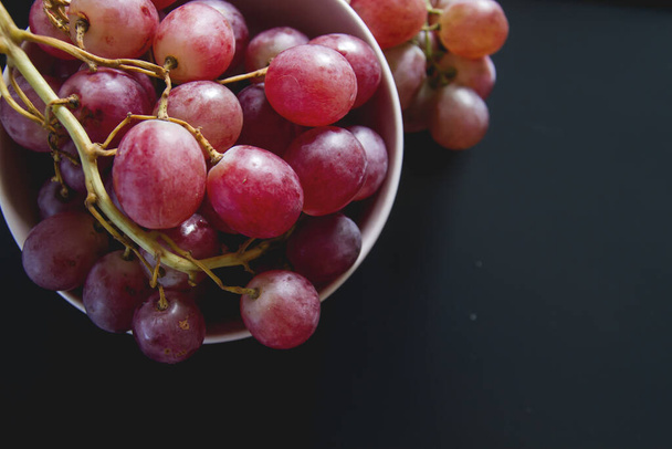A bowl with fresh red grapes  - Fotó, kép