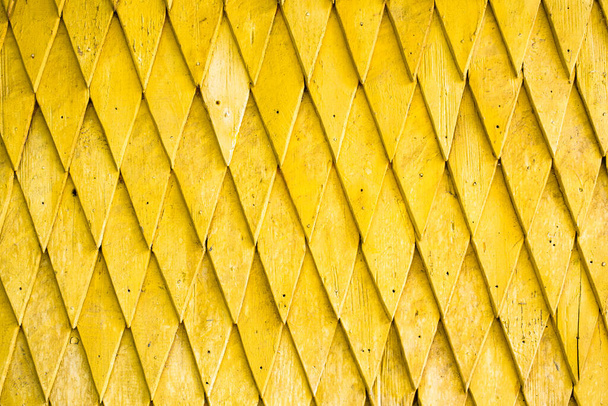 Yellow painted wooden shingle surface with rich texture. - Photo, Image