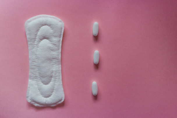 flat lay of feminine hygiene items. Details for critical women's days on a turquoise background. Gaskets for women, health. Analgesic pills - Photo, Image